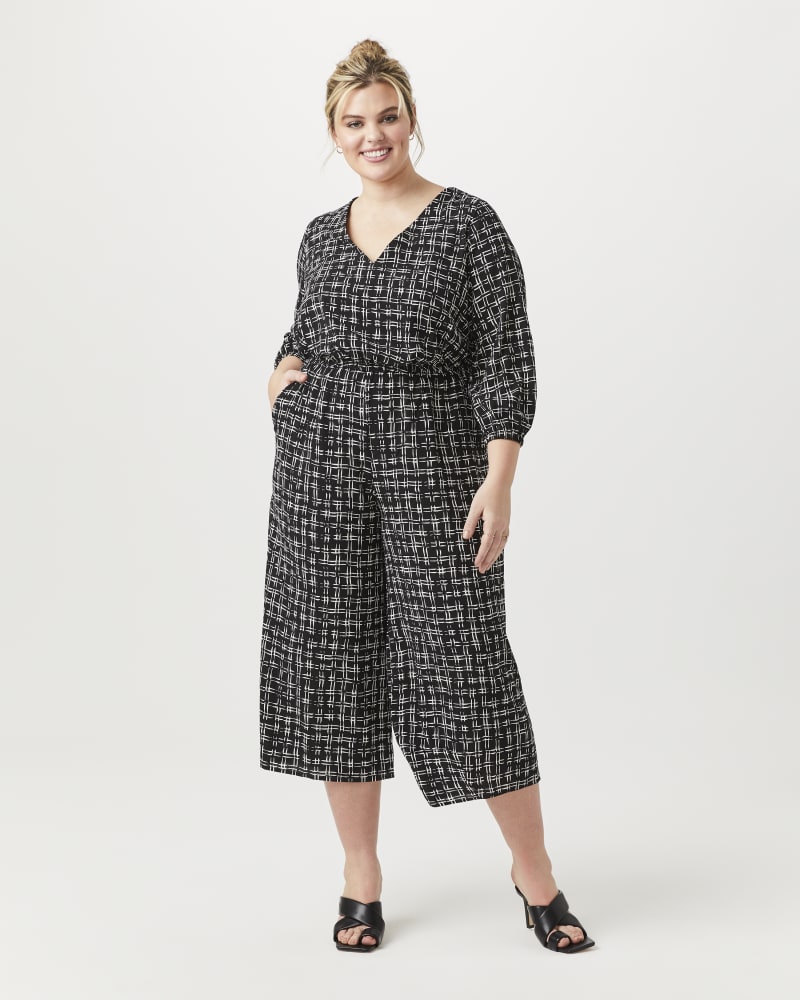 Plus size model with hourglass body shape wearing Viveka V-Neck Jumpsuit by Sabrina Collective | Dia&Co | dia_product_style_image_id:152030